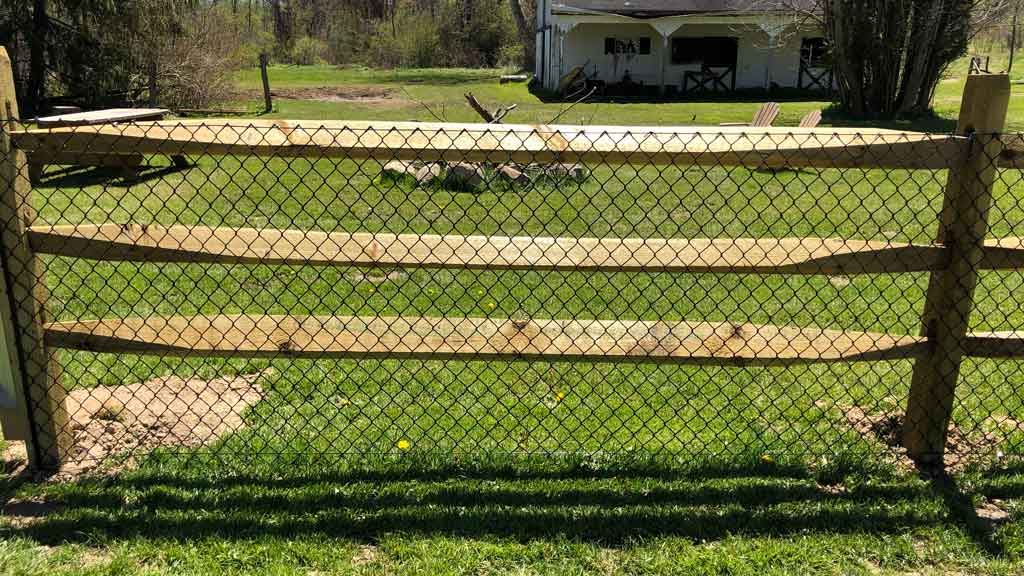 Black Chain Link Mesh on Wood Split Rail Fence