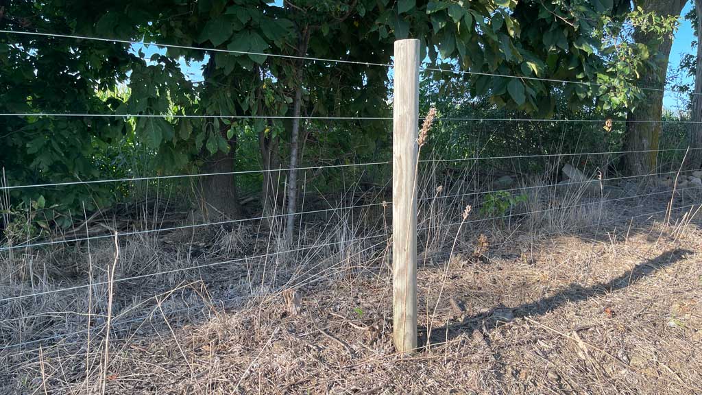 Round wooden fence post