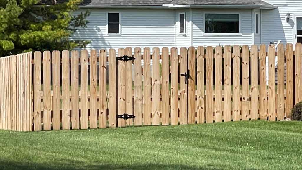 man gate on wood fence