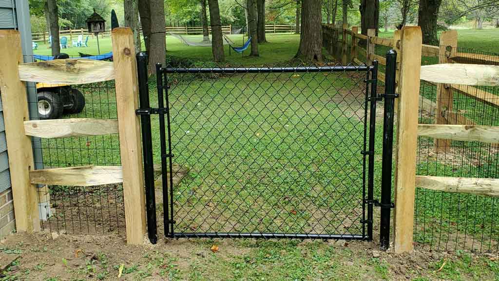 split rial fence with chain link gate