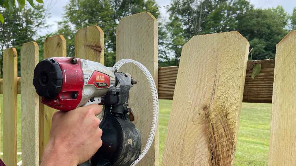 nail gun nailing wood shadowbox fence pickets