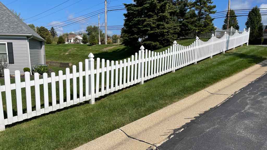 vinyl picket fence built on a slope