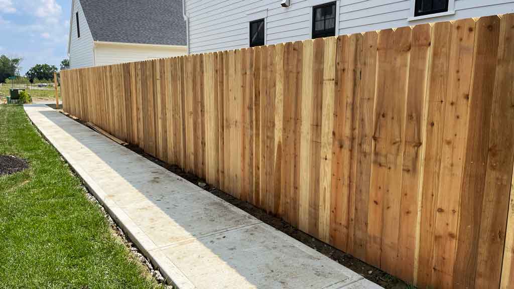 solid board fence with cedar pickets