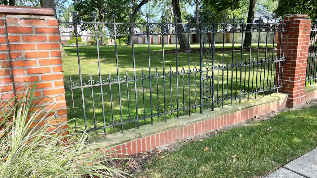 fence mounted between brick pillars