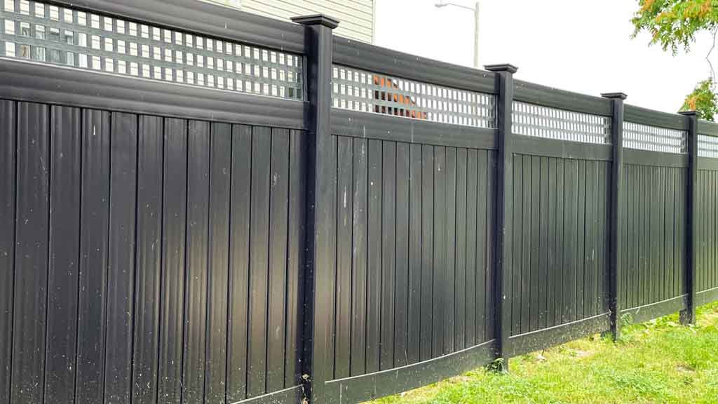 black vinyl privacy fence with lattice.