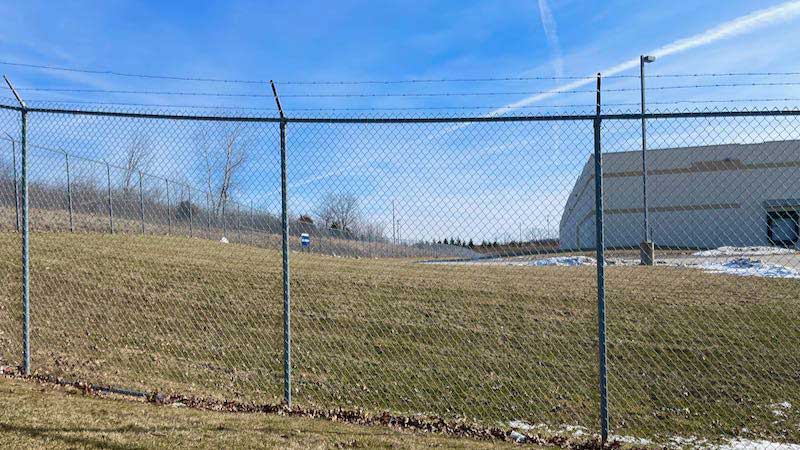 10' chain link with barbed wire